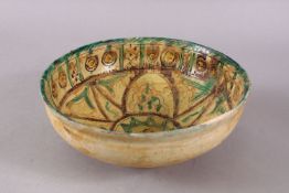 A GOOD IRAN STYLE POTTERY BOWL, decorated with green & biscuit grounds with floral motifs, 21cm.