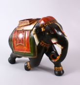 AN INDIAN LACQUER MODEL ELEPHANT, with decorated wears, 30cm wide
