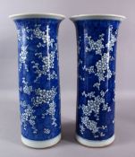 A LARGE PAIR OF 19TH CENTURY CYLINDRICAL BLUE AND WHITE PRUNUS VASES, both approx. 45cm high.