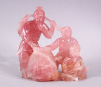 A GOOD CHINESE CARVED ROSE QUARTZ FISHERMAN GROUP, the fisherman stood holding his catch with his