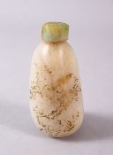 A CHINESE CARVED JADE SNUFF BOTTLE, with trace gilt decoration of birds and flora, 7.5cm high