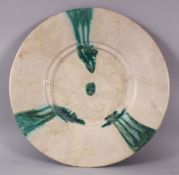 A 12TH CENTURY ABBASID POTTERY PLATE, with green drip decoration, 34cm.
