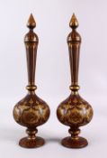 A PAIR OF ISLAMIC DAMASCENE INLAID STEEL BOTTLE & COVERS, each with gold inlaid panels of star