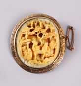 A CHINESE CANTON CARVED IVORY BROOCH, mounted in gold coloured metal ( possibly gold ), carved