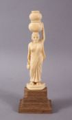 A 19TH CENTURY INDIAN CARVED IVORY FIGURE of female carrying a water vessel, 16cm high.