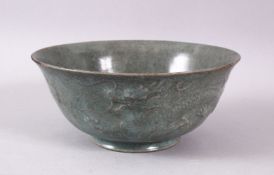 A CHINESE CELADON PORCELAIN DRAGON BOWL, the body with moulded dragons, 15cm.