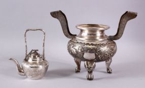 A CHINESE SILVER TWO HANDLED KORO and a small teapot and cover.