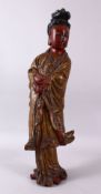 A LARGE CHINESE WOOD & LACQUER FIGURE OF GUANYIN, stood holding a scroll with her hands crossed,