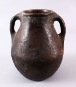 A 10TH CENTURY IRANIAN POTTERY TWIN HANDLE JUG, 22cm high.
