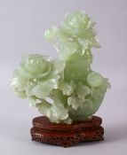 A CHINESE CARVED GREEN JADE FLORAL VASE, COVER & STAND, the vase enclosed with carved floral
