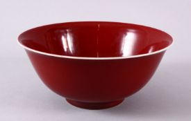 A CHINESE MING STYLE COPPER RED PORCELAIN BOWL, the base with a six character mark and label, 21.