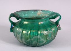 A RARE EARLY ISLAMIC OR ROMAN BLUE GLASS TWIN HANDLED BOWL, with twin moulded handles and a flared