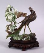 A CHINESE CARVED JADEITE FIGURE OF A PEACOCK & FLORA, the peacock stood upon a rocky outcrop ith