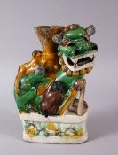 A CHINESE FAMILLE VERTE POTTERY LION DOG FIGURE, with boys climbing upon the dog, with a vase form