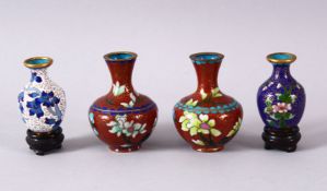 FOUR SMALL CHINESE CLOISONNE VASES - one pair with red ground and flora, 6.5cm, together ith two