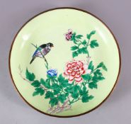 A CHINESE ENAMEL FLORAL DISH, the dish with a pale lime green ground depicting a bird seated in