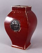 A CHINESE SQUAT SQUARE FORM SANG DE BOEUF PORCELAIN VASE, with a graduating glaze and a central