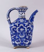 A POSSIBLE EARLY IZNIK BLUE & WHITE WATER FLASK, decorated with floral motif decorations, 22cm