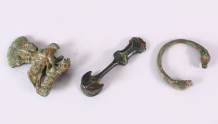 AN EARLY PERSIAN BRONZE ZOOMORPHIC AXE HEAD, together with bangle and dagger handle, axe 12cm high.