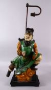 A CHINESE SANCAI GLAZED FIGURE OF A WARRIOR AS A LAMP, the figure fitted to a wooden base with light