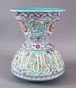 AN ISLAMIC TURQUOISE POTTERY CALLIGRAPHIC MOSQUE LAMP, with raised bands of calligraphy and floral