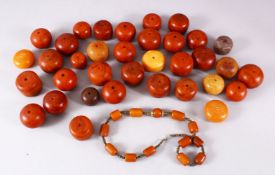 A LARGE LOT OF BAKELITE OR CHERRY AMBER STYLE CARVED BEADS, comprising 35 large beads and a necklace