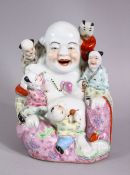 A CHINESE REPUBLIC STYLE FAMILLE ROSE PORCELAIN FIGURE OF BUDDHA, seated with boys, 17cm high