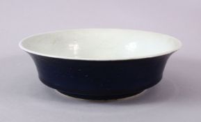 A CHINESE MING STYLE BLUE GLAZE PORCELAIN BOWL, decorated with scrolling lotus and waves, the