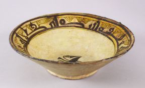 AN EARLY KASHAN POTTERY BOWL WITH KUFIC SCRIPT, the interior of the bowl with a bird central with