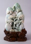 A CHINESE CARVED JADEITE LANDSCAPE STONE, carved depicting a native landscape with pine trees and an