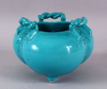 A CHINESE TURQUOISE GLAZED TRIPLE FOOT PORCELAIN CENSER, with twisted rope handles, 12cm