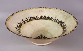 A LARGE NISHABOUR POTTERY BOWL, with banded script decoration interior with a central symbol, 35cm.