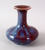 A CHINESE FLAMBE PORCELAIN VASE, with a graduated red - blue glaze, base unglazed, 11.5cm high