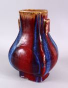 A CHINESE FLAMBE GLAZED PORCELAIN TWIN HANDLE VASE, 27cm