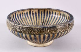AN EARLY NISHAPUR POTTERY BOWL, the exterior with bands off calligraphy , with blue stripe