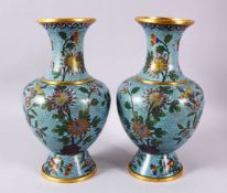 A PAIR OF CHINESE CLOISONNE BLUE GROUND VASES, each with a pale blue ground and native views of