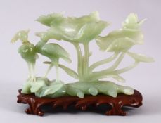 A CHINESE 20TH CENTURY CARVED JADE FIGURE & STAND, the figure carved to depict phoenix birds aside