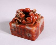 A CHINESE CARVED SOAPSTONE SEAL, carved with chilong and calligraphy, 5cm