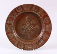 A 19TH CENTURY ISLAMIC CALLIGRAPHIC COPPER DISH, with floral motif and panels of calligraphy, 24cm