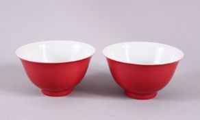 A PAIR OF 19TH / 20TH CENTURY CHINESE RUBY RED GLAZED PORCELAIN TEA BOWLS, with a ruby red / pink