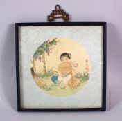 A SMALL CHINESE FRAMED PAINTING ON SILK - the cut out section depicting a young girl seated in a