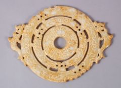 A CHINESE CARVED SOAPSTONE BI DISK, carved in archaic form with chilong, 22cm
