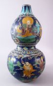 A CHINESE MING FAHUA DOUBLE GOURD PORCELAIN CARVED VASE, decorated with figures including luohan,