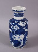 A 19TH CENTURY CHINESE BLUE AND WHITE PRUNUS ROULEAU VASE, the base with Kangxi mark, 15cm high.