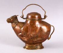 A 19TH CENTURY INDIAN COPPER EWER in the form of a cow, 22cm long.