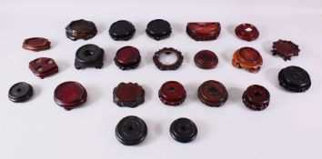 A MIXED LOT OF 20 CHINESE CARVED HARDWOOD STANDS - each of varying size, style and timber, the