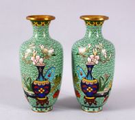 A PAIR OF CHINESE CLOISONNE APPLE GREEN GROUND VASES - each with a green ground with native