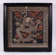 A CHINESE FRAMED FIVE CLAW DRAGON TAPESTRY, the five claw dragon and clouds detailed in metallic