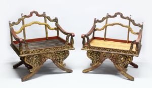 A SUPERB PAIR OF 19TH/20TH CENTURY THAI CARVED HOWDAH ELEPHANT CHAIRS, profusely carved and