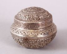 A SMALL INDIAN CIRCULAR WHITE METAL BOX & COVER, possibly silver, with moulded floral decoration,